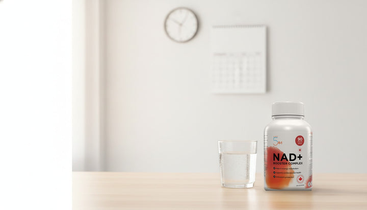 Live 5AM NAD+ Booster Complex bottle, 90 capsules, NPN 80145698, beside a glass of water on a bright morning desk