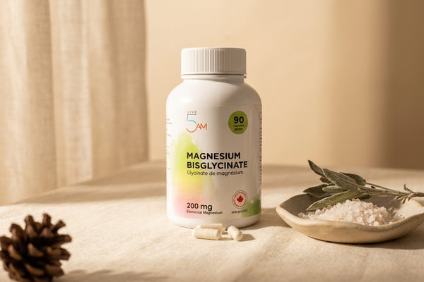 Live 5AM Magnesium Bisglycinate 200mg bottle on cream linen with sage and mineral salt in soft Canadian morning light.