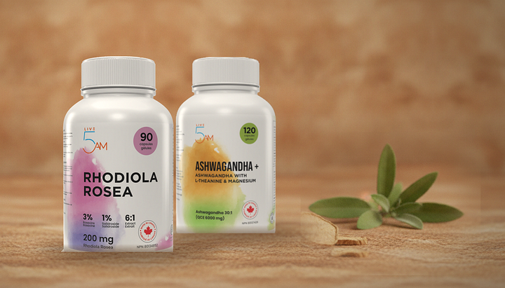 Live 5AM Rhodiola Rosea 200 mg and Ashwagandha + bottles side by side on a wooden surface with sage leaves and dried rhodiola root